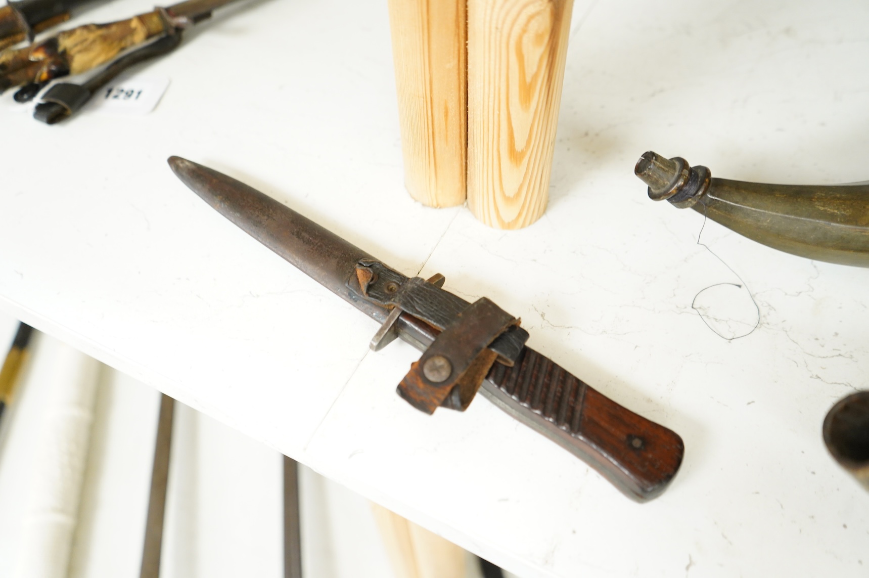 A First World War German Fighting Knife, with two piece wooden grip and steel cross guard, in original steel scabbard with leather belt loop mount, single edged blade with makers mark to one side; Gottlieb Hammesfahr, So
